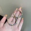 Twisted gold hoop earrings with purple rhinestones, stylish geometric circle design - Twisted Rhinestone Hoop (E3870) / 3.8CM / Gold Purple