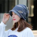 Elegant women's grey knitted brimmed beanie hat with a golden feather print motif - One Size (Stretchy) / Blue Grey (Leaf Print)