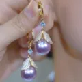 Close-up view of elegant purple pearl drop earrings with pavé-set leaf details - Gold Rhinestone Leaf Purple Pearl Style (E4500)