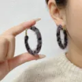 Close-up detail of fuzzy leopard print hoop earrings in a retro French style - Large (E4421) / 5cm / Grey Leopard