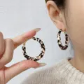 Detailed view of stylish retro leopard print leather hoop earrings worn by a model - 4cm / Light Coffee and Black