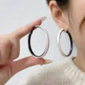 Stylish large black and white geometric hoop earrings with a minimalist matte finish design - White