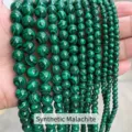 Macro detail of high-quality synthetic malachite round beads with unique green stripes - 4mm (Approx 90pcs) / Synthetic Malachite
