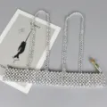 Detail of silver beaded harness belt with reflective metallic beads on grey surface. - Wide Style / Silver