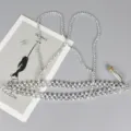 Detailed close-up of a stylish silver beaded harness waist chain belt for fashion. - Thin Silver Crossover