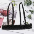 Detailed view of black beaded harness belt with suspender straps on magazine - Wide Style / Black