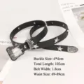 Detail view of black punk belt with star studs and ornate silver buckle with dimensions. - Black