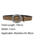 Detailed view of brown retro Y2K ethnic belt with floral pattern and silver buckle - Brown