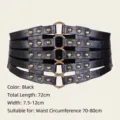 Detail of black crocodile texture corset belt with golden rivets and ring buckles. - Black