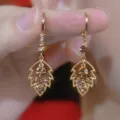 Gold leaf drop earrings with sparkling coffee and clear crystals shown in close-up detail. - Hollow Leaf Style (E4497) / Gold