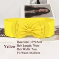 Yellow wide elastic cinch belt for women featuring a large decorative bow detail - Yellow