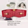 Red wide elastic cinch belt for women featuring a large leather bow and gold buckle detail - Red