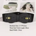 Elegant black elastic waist belt with large textured bow buckle and gold accents - Black