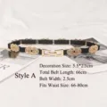 Women's black elastic waist belt with gold decorative buckle and chain Style A variant - Hollow-out Floral Interlocking Style (XH785) / 66cmx2.5cm