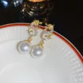 Elegant gold dragon drop earrings with white pearl and sparkling rhinestones - Dragon Year White Pearl Drop Earrings / Gold White