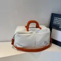 White large-capacity foldable travel bag with vibrant orange handles - One Size / Off White