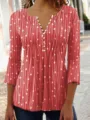 Close-up detail of women's red V-neck blouse featuring elegant white polka dot and line print - S / Tops / Red
