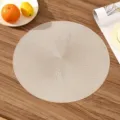 Detailed top view of elegant round gold PVC placemat with a premium spiral texture finish - Style A (Spiral Pattern) / Gold