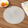 Detailed view of silver round PVC placemat with spiral sunburst texture - Style A (Spiral Pattern) / Silver