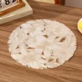 Detailed close-up view of French romantic floral lace PVC placemat for dining table - Style B (Hollow Floral) / Gold