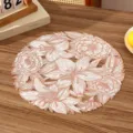 High-quality close-up of white and rose gold floral hollow PVC placemat on a wooden table. - Style B (Hollow Floral) / Rose Gold