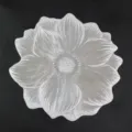 Silver flower-shaped PVC placemat with intricate petal texture and heat resistance. - Style D (Blooming Flower) / Silver