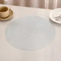 Detail view of a white round PVC placemat with elegant woven texture on a table - G款 (镂空编织) / Silver