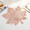 Detailed macro view of an elegant rose gold maple leaf hollow PVC heat resistant placemat - Style H (Maple Leaf Shape) / Rose Gold
