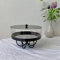 Detailed macro view of round acrylic dessert stand with black lid and elegant base - 21.5*21.5*16 / Black