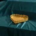 Ornate heart-shaped golden metal tray on dark green velvet for wedding or home decor - Heart