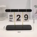 Minimalist black wooden desktop flip calendar with gold metal rods and white date cards - Black Wood Stripe Calendar