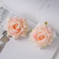 Close-up of champagne silk rose heads with realistic curled petals for decor. - Champagne