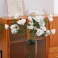 Elegantly arranged white artificial Lisianthus flowers in a vase for modern home decor - White