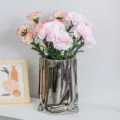 Realistic pink artificial carnations set in a modern irregular metallic silver vase for decor - Light Pink