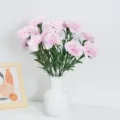 Vibrant pink artificial carnations in a stylish white vase for home decor - Pink
