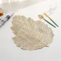 Elegant golden leaf-shaped PVC placemat for heat-resistant table setting. - Style M (Leaf-Shaped Hollow) / Gold