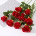 Close-up of lifelike artificial red silk roses with natural petal texture and green leaves - Red