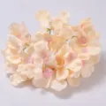 Artificial silk hydrangea flower head in light yellow with pink center detail close-up - Champagne
