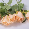 Close-up of champagne-colored artificial silk snow mountain rose for home decor - Champagne