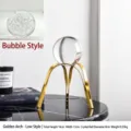 Luxury clear crystal ball with a modern golden arched metal stand for desk decor - 16x13x10cm / Golden Arch Small (Bubble Crystal)