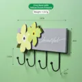 Minimalist floral wall hook rack with grey wood base and 4 black iron hooks - Grey Yellow Green