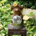 Highland cow solar garden statue with sunflower and crackle glass ball, variant view - Holding Ball Highland Cow