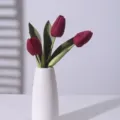 Elegant deep red artificial tulips in minimalist white ceramic vase for chic home decoration - Red