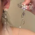 Close-up of long white snowflake earrings featuring delicate tassels and pearl accents - Snowflake Butterfly Tassel Earrings (E3686) / Silver