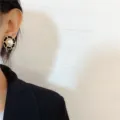 Close-up of elegant Chanel-style round pearl stud earring with gold chain border - Chain Border Black Disc Large Artificial Pearl Stud (E3716) / Gold