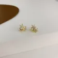 Close-up of gold clustered star stud earrings with sparkling cubic zirconia detail. - Star Clusters Style (E0570) / Gold