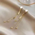 Elegant gold-tone long tassel earrings featuring twisted metal and square shell studs - Minimalist Tassel Style (E0136) / Gold