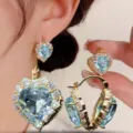 Elegant heart-shaped halo earrings featuring light blue crystal and gold plating - Heart-Shaped Rhinestone Halo Hook Earrings (E3249) / Light Blue