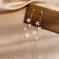 Elegant gold-tone long tassel earrings with dainty white flower charms and crystal accents - Korean Small Flower Tassel (E0882) / Gold
