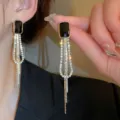 Elegant long gold tassel earrings featuring a black rectangular gemstone and crystals - Black Gemstone Tassel Style (E3464) / Black